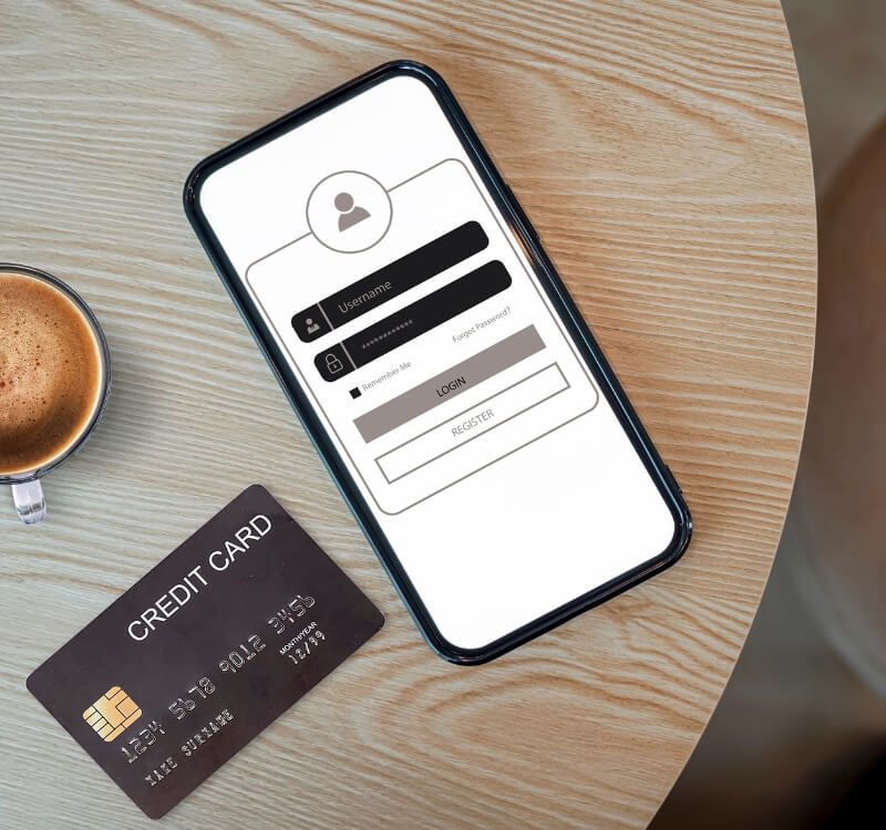 smart phone with login page and credit card on table
